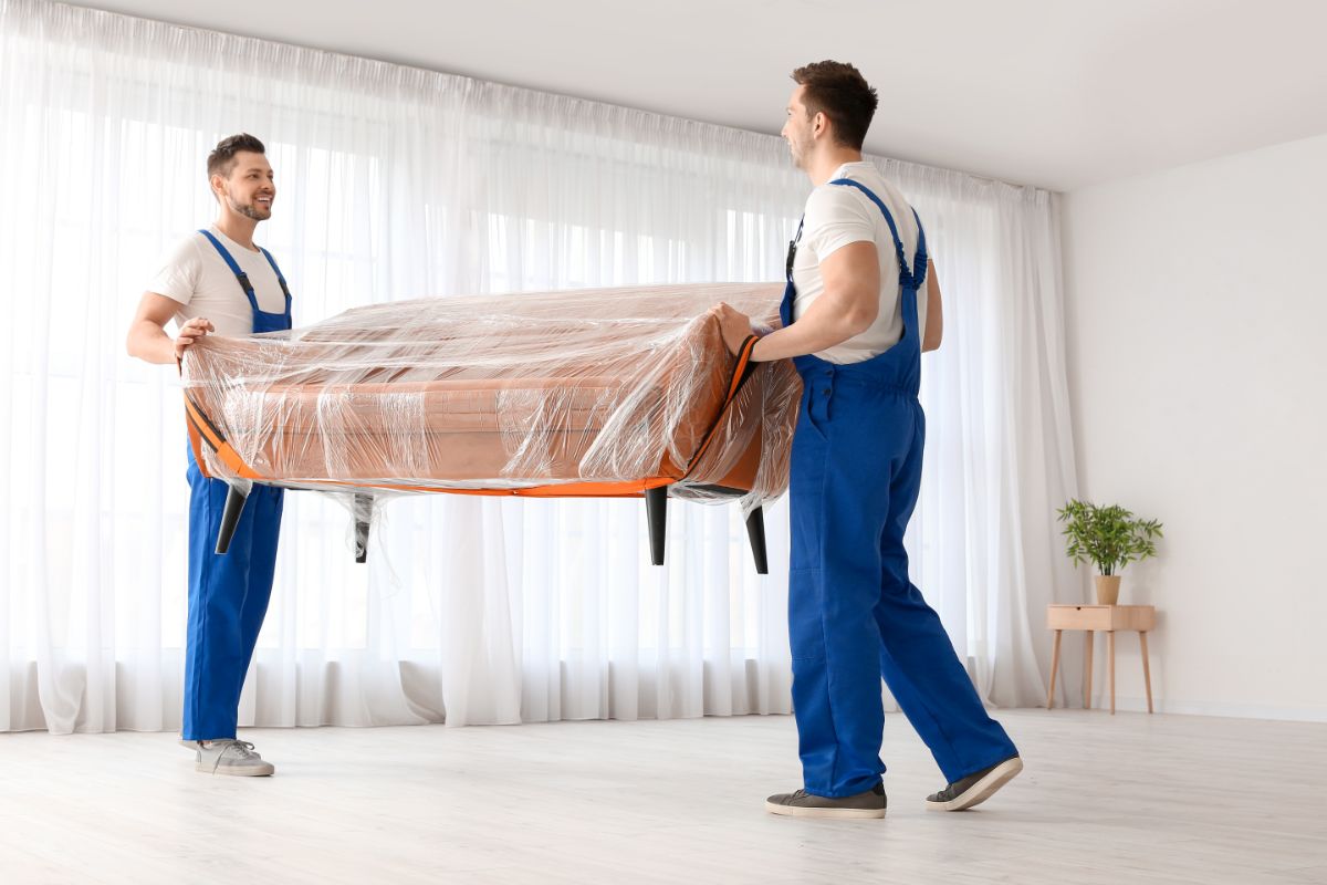 two men carrying sofa for move out cleaning